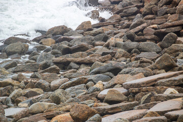 Stones and the sea on a Rio de Janeiro beach for background.