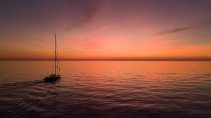 Superyacht sailing boat sunset over the sea