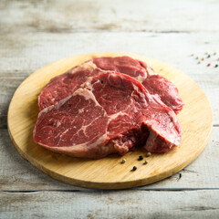 Raw beef steak on wooden desk