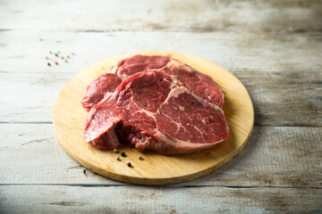 Raw beef steak on wooden desk