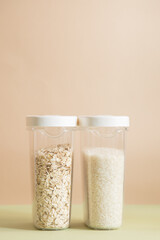 Plastic containers with cereals. Home storage products. Rice and oat.