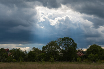 Obraz premium Magic Blueish Light Passing through the Dark Stormy Clouds