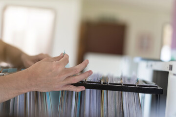 Man looking in a documentation file drawer