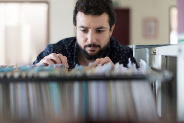 Man looking in a documentation file drawer