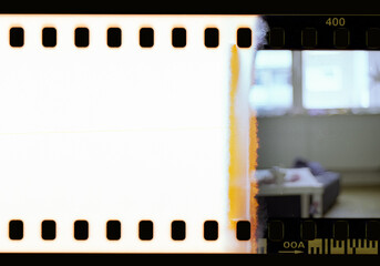 Start of an real 35mm filmstrip with burned middle part, cool film texture.