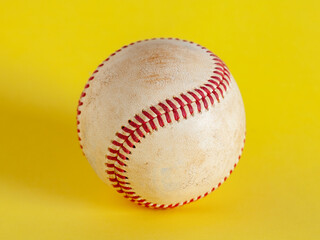 worn baseball isolated on yellow background, team sport