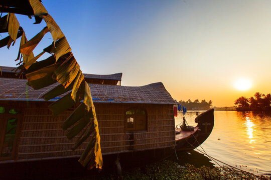 Kerala houseboat with banana palm on sunset, South India