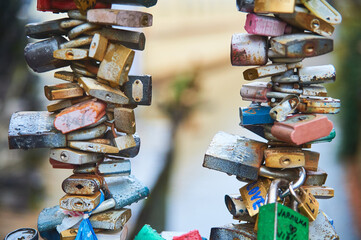 colorful love padlocks fastened on a bridge in Prague