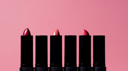 set of six lipsticks of different shades lined up exactly in a line,