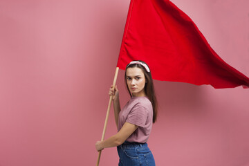 activist and revolutionary, young woman with a red flag on a pink background.