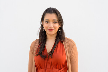 Face of young beautiful Indian woman against white background