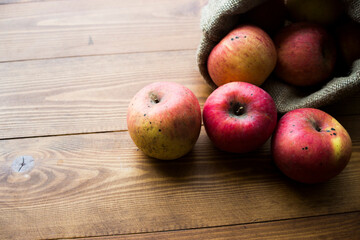 apples in a bag on a wooden background, free space for text