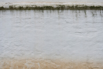 Old white wall, mold on top, dirt on the bottom. Background, texture.