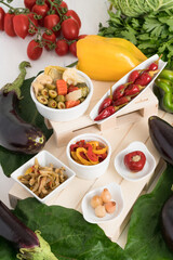 Composition of vegetables in oil composed of "gypsy" peppers, tomatoes stuffed with tuna, country aubergines and Lampascioni. Preserves prepared at home as a side dish or appetizer typical of souther