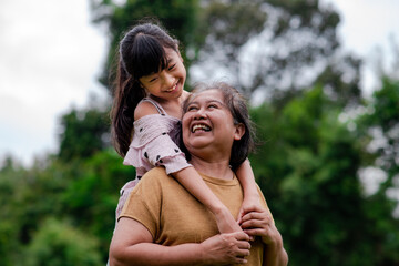 Grandmother and granddaughter enjoyed in the garden.Asian family conception