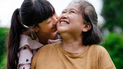 Grandmother and granddaughter enjoyed in the garden.Asian family conception