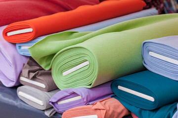 Colourful bales of fabric on a market