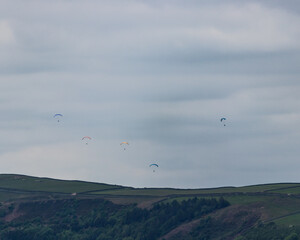 six paraglider above the hope valley in the peak district