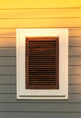 the close window and sunlight from the sun on the wooden wall