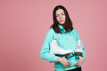 Figure skating for adults, Hobbies and a healthy lifestyle. A young woman in a bright sweatshirt...
