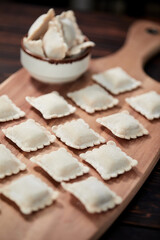 raw dumplings on teh wooden board