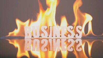 Business bankruptcy concept. Companies go bankrupt, people are left out of work. Global economic crisis. Paper word BUSINESS burns in a fire