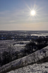 Panorama in the frosty haze from Spasskaya Mountain. Sunny winter day in the foothills of the Western Urals.