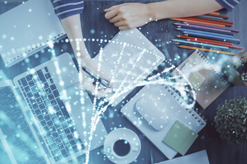 DNA theme hologram over woman's hands writing background. Concept of education. Double exposure