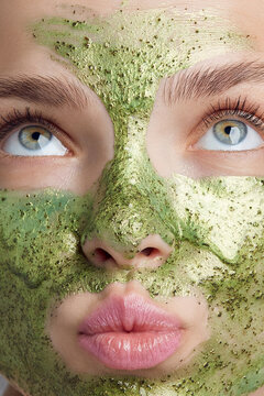 Face masks are the perfect treatment to hydrate skin, remove excess oils and improve the appearance of pores. Cropped shot of a lady's face with pouted lips and green speckled mask on the skin.