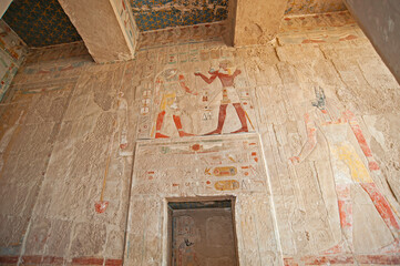 Hieroglyphic carvings on an ancient egyptian temple wall