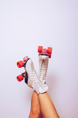 girl with legs up wearing a white 70s roller skates