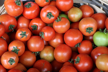 Box of tomatoes sold at the stall of a fruit and vegetable market