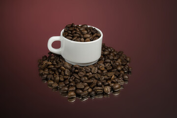 Paper cup of coffee and coffee beans on red