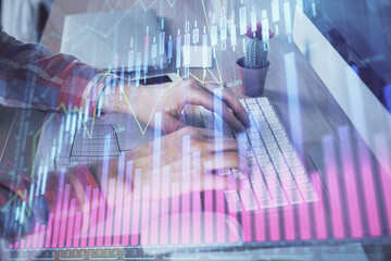 Double exposure of stock market chart with man working on computer on background. Concept of financial analysis.