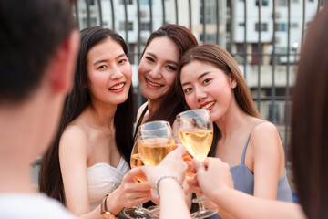 Group of young Asian friends are toasting or cheering