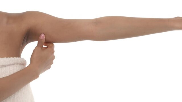 Close-up of a woman showing flabby arm, effect of aging caused by loss of elasticity and muscle. Isolated on white background