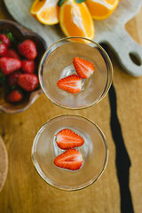 Champagne with strawberries in a glass. Cocktail with strawberries.