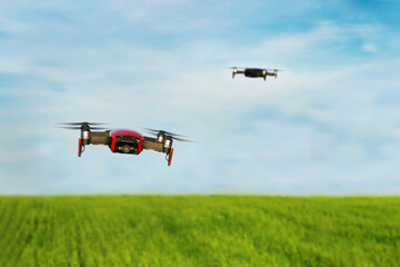 Drones flying in the frame. Quadcopter looks into the camera.