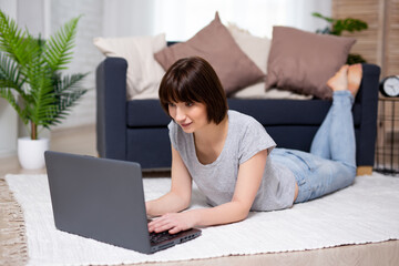 portrait of young woman or teenage girl using laptop at home