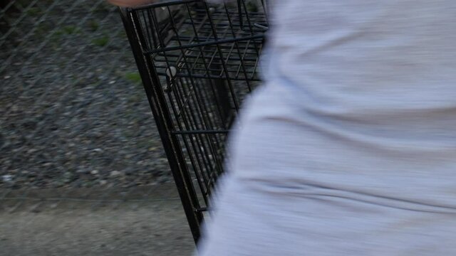 Grocery Store Worker Wipes Down And Sanitize A Shopping Cart During The COVID-19 Pandemic