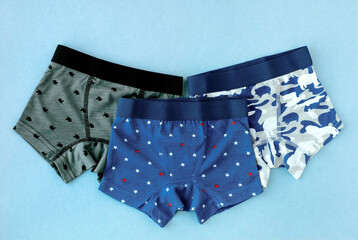 Underwear for a boy. Children's underwear in the form of panties for a boy. Soft knit shorts on a blue background. A set of panties for a child.