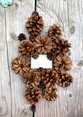 stylish wooden background with pine cones, copy space for text. seasonal holidays and SPA concept