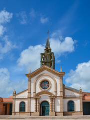 Fototapeta na wymiar Le Francois, Martinique - September 18, 2018: Eglise catholique de Saint-Michel, Catholic Church of Saint Michael. Blue sky, white clouds. Copy space