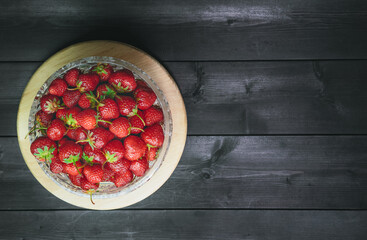 Ripe strawberries on a wooden background