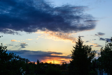 Fototapeta premium clouds and sunset over the village in spring4