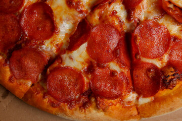Pizza. spicy pizza on a cardboard box. Tasty pizza with bacon, salami and cheese.Background pizza pepperoni.