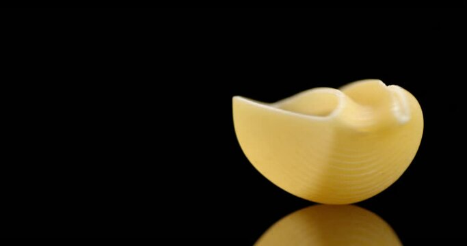 One pasta dry rigati rotates slowly on the table.