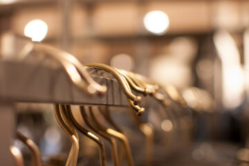 hanger hanging on the stand in a clothing shop
