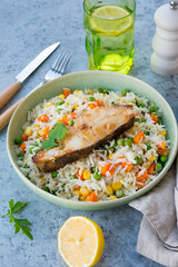 Rice with vegetables and fish steak, traditional asian food