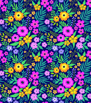 Amazing seamless floral pattern with bright colorful flowers and leaves on a dark blue background. The elegant the template for fashion prints. Modern floral background. Folk style. © ann_and_pen